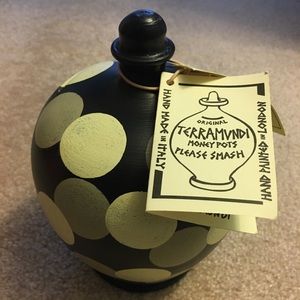 Terramvndi money pot with a few coins inside